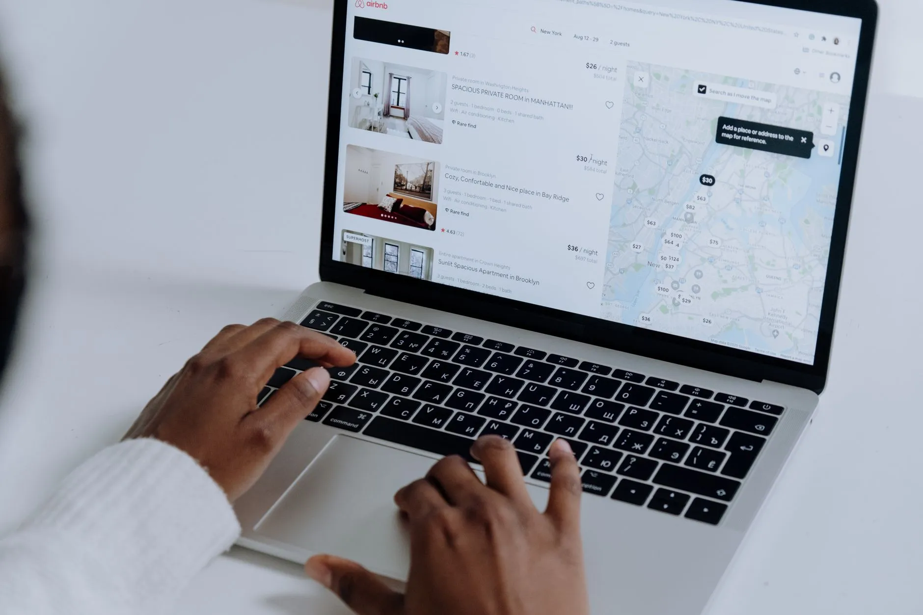 A guest choosing a place to stay on a booking channel website: a list of listings next to a city map